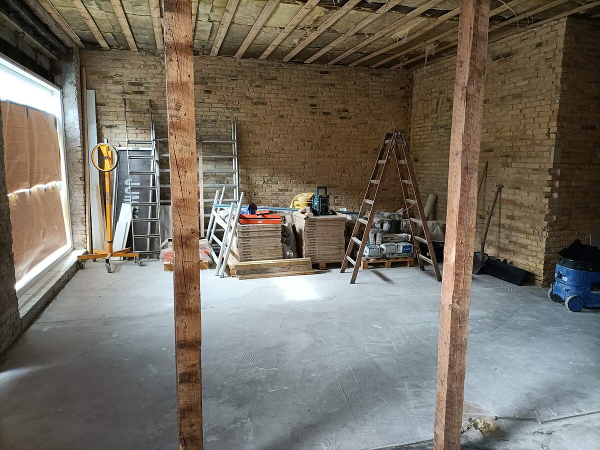 Det ene butikslokale under renovering med blotlagte bjælker